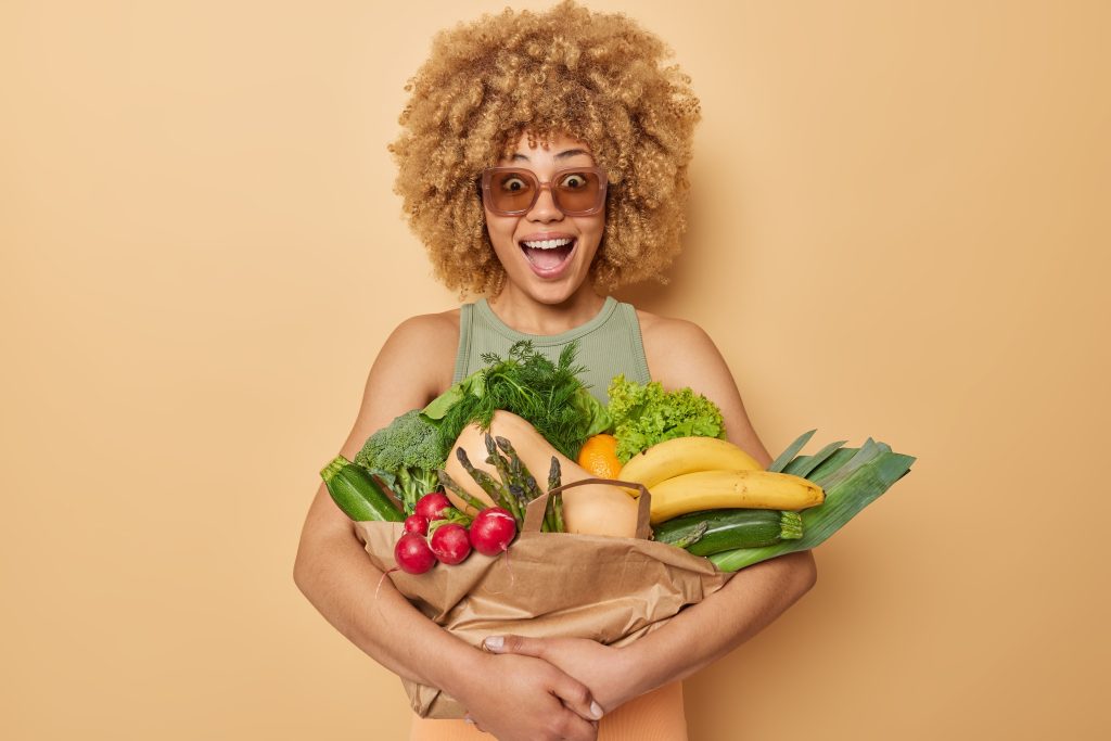 horizontal-shot-surprised-amazed-curly-haired-young-woman-embraces-fresh-vegetables-fruits-wrapped-p.jpeg